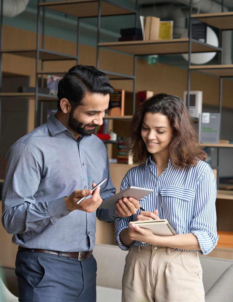 diverse-friendly-coworkers-talking-using-digital-tablet-in-office-.jpg